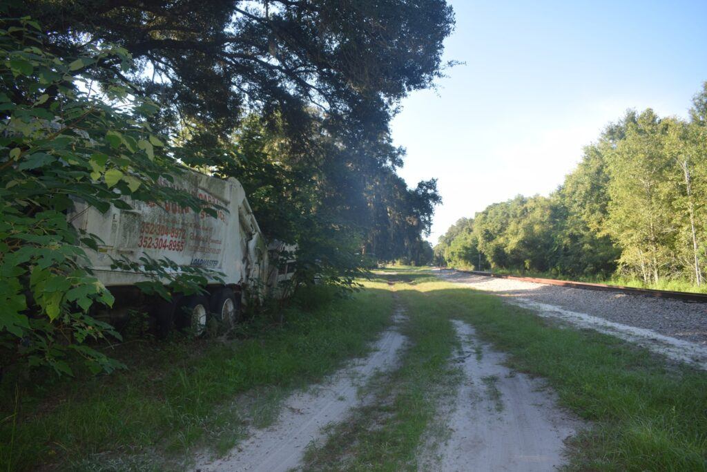 Railroad tracks and overgrown roadside in the former community of Romeo, Florida