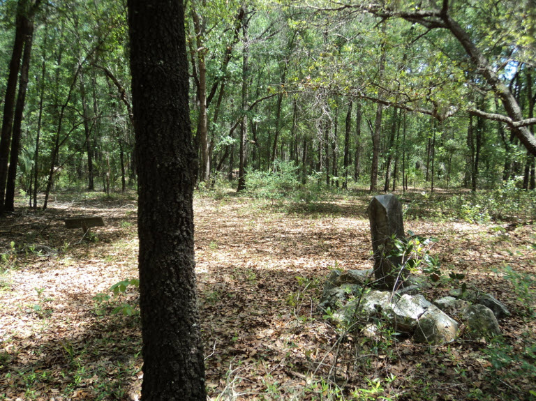Old grave marker among the trees in Juliette Cemetery near Rainbow Springs, Florida