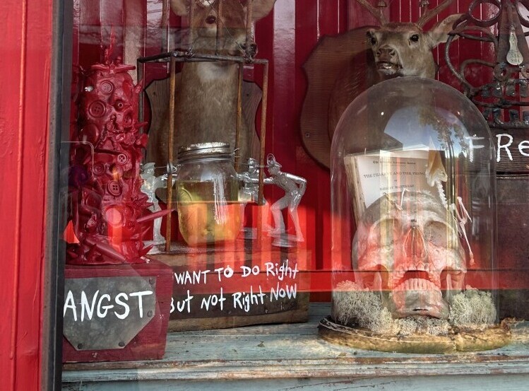 Entrance view of the Museum of Wonder Drive Thru in Seale, Alabama, showing eclectic roadside displays and unusual objects visible from the drive-through path.