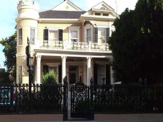 Front view of the Cornstalk Hotel in New Orleans with ornate black iron cornstalk fence.