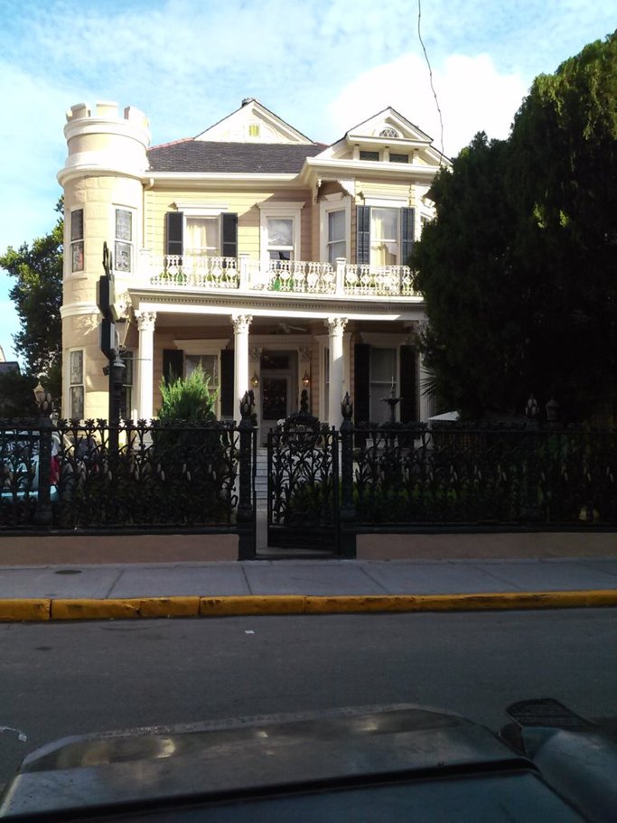 Front view of the Cornstalk Hotel in New Orleans with ornate black iron cornstalk fence.