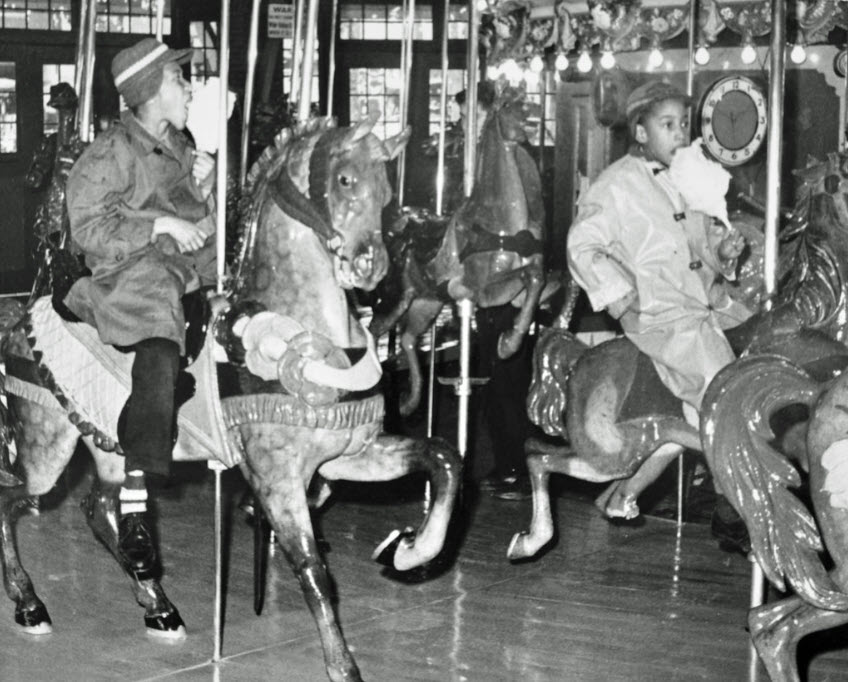 Kids riding the Carousel after desegregation