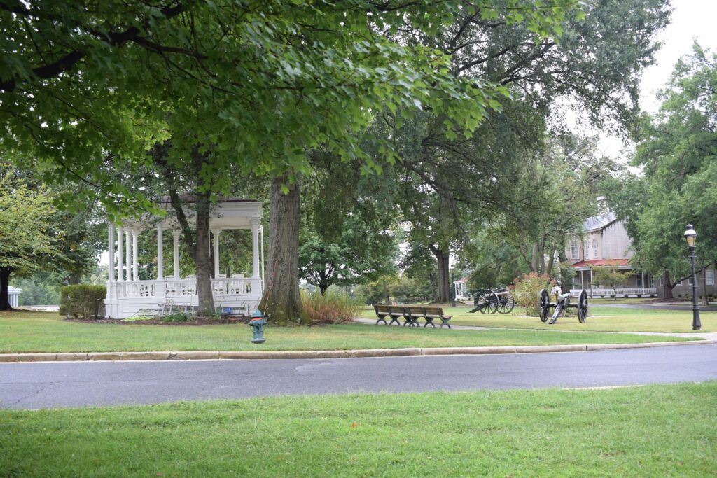 Shaded pathway on the Soldiers’ Home property, framed by old trees and quiet green space, reflecting the peaceful environment designed for veterans.