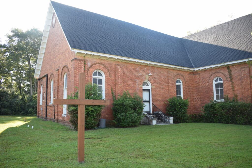 Side profile of Cherry Street AME Church, including the attached building and surrounding greenery.