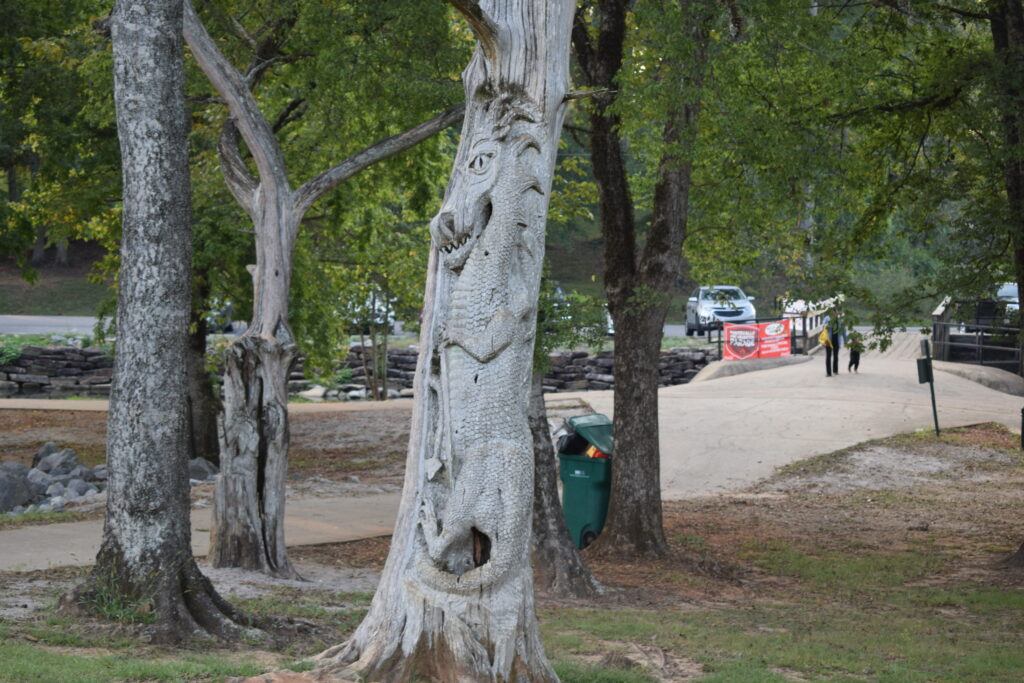 Dragon sculpture carved from a dead cedar tree in Orr Park, one of the signature Tinglewood chainsaw art pieces.