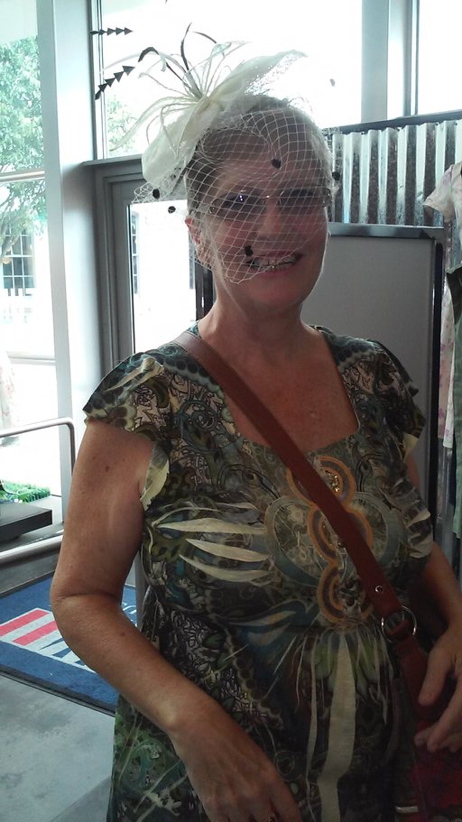 Woman wearing a vintage 1940s-style hat inside the National WWII Museum gift shop in New Orleans.