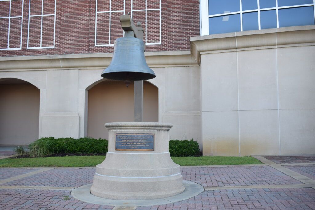 The preserved bell from the original Houston County Courthouse, now displayed on a stone pedestal in downtown Dothan, Alabama.
