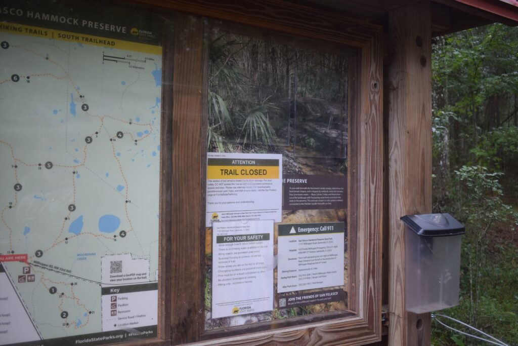 Trailhead map and information board at San Felasco Hammock Preserve State Park displaying a “Trail Closed” notice after storm damage.