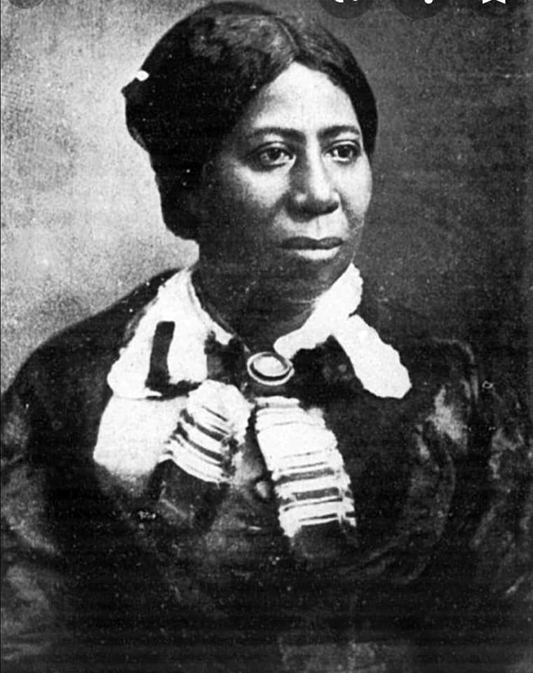 Black-and-white historical portrait of Anna Madgigine Jai Kingsley, shown from the chest up, wearing a dark dress with a light ruffled collar and her hair pulled back, looking slightly to the side with a calm, composed expression.