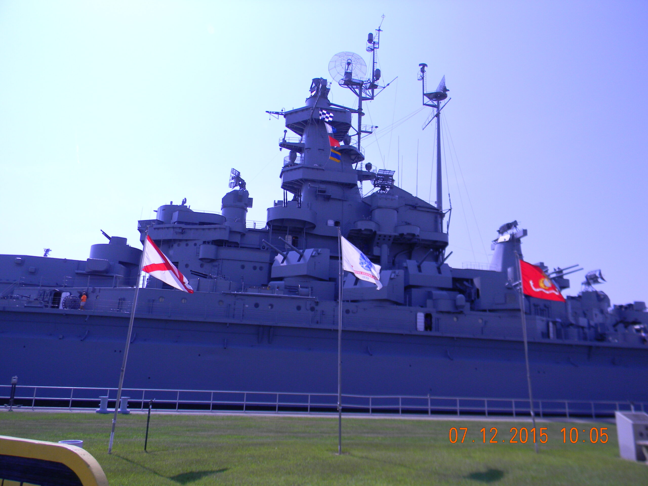 The USS Alabama battleship docked at Battleship Memorial Park in Mobile, Alabama, viewed from the shore.