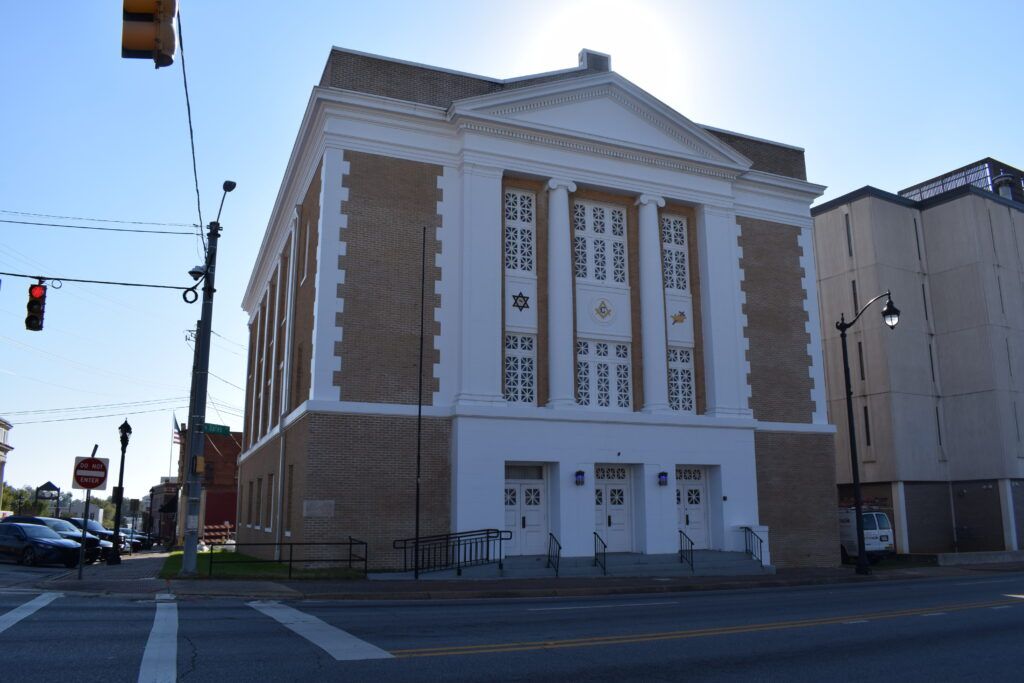 Front view of the William L. Lee Grandmaster Building in downtown Dothan, Alabama, showing historic brick architecture and street-level perspective