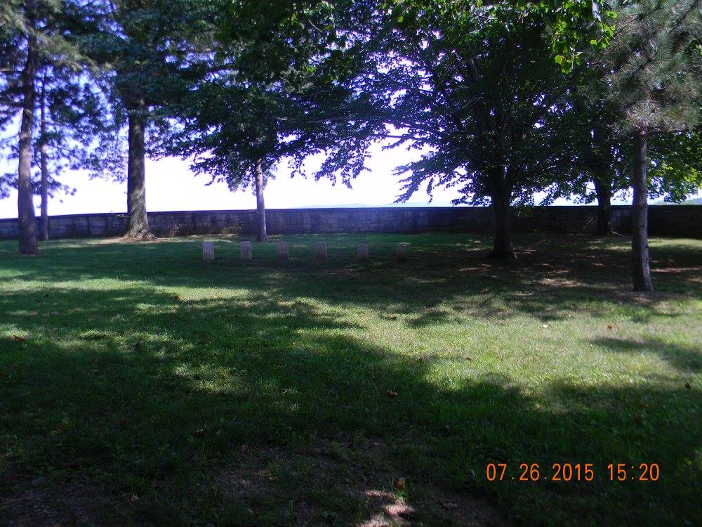 Quiet corner of Antietam National Cemetery where African American soldiers were historically buried in segregation, marked by a small row of headstones beneath shaded trees