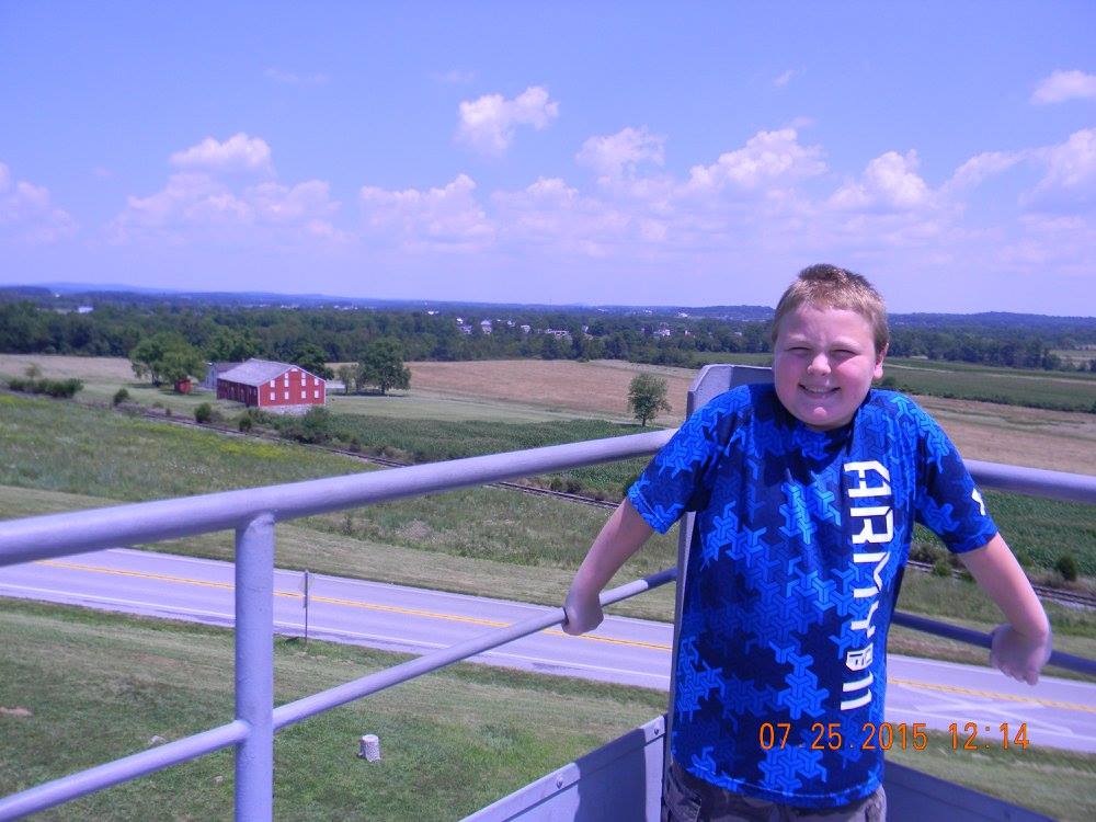 Child standing on a Gettysburg observation tower overlooking the Gettysburg battlefield and Pennsylvania farmland