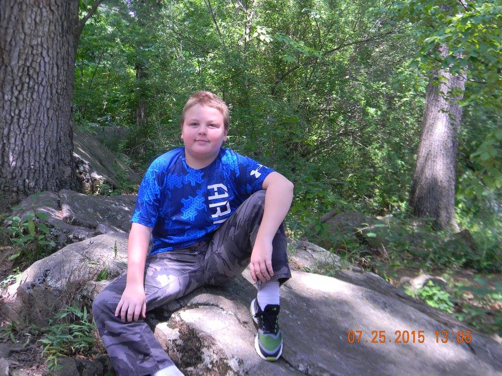 Child sitting on a large rock at Little Round Top in Gettysburg National Military Park