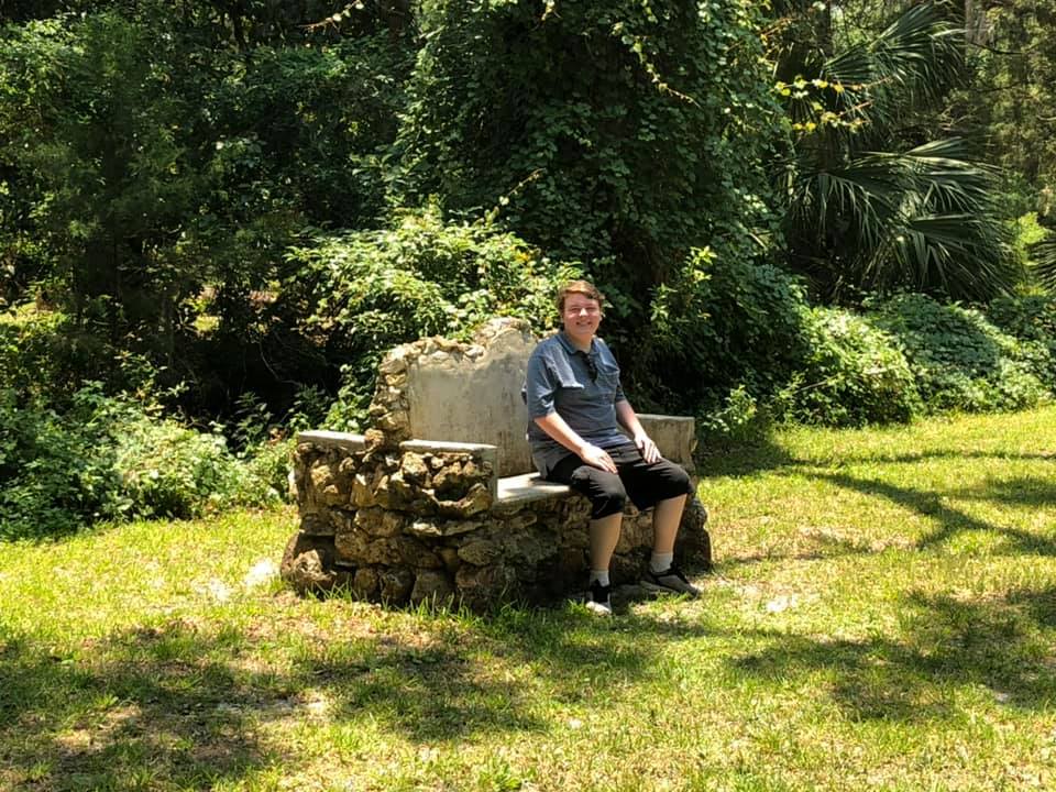 My son resting on a stone bench at Dade Battlefield Historic State Park during their 2019 visit, shortly before his spinal surgery.