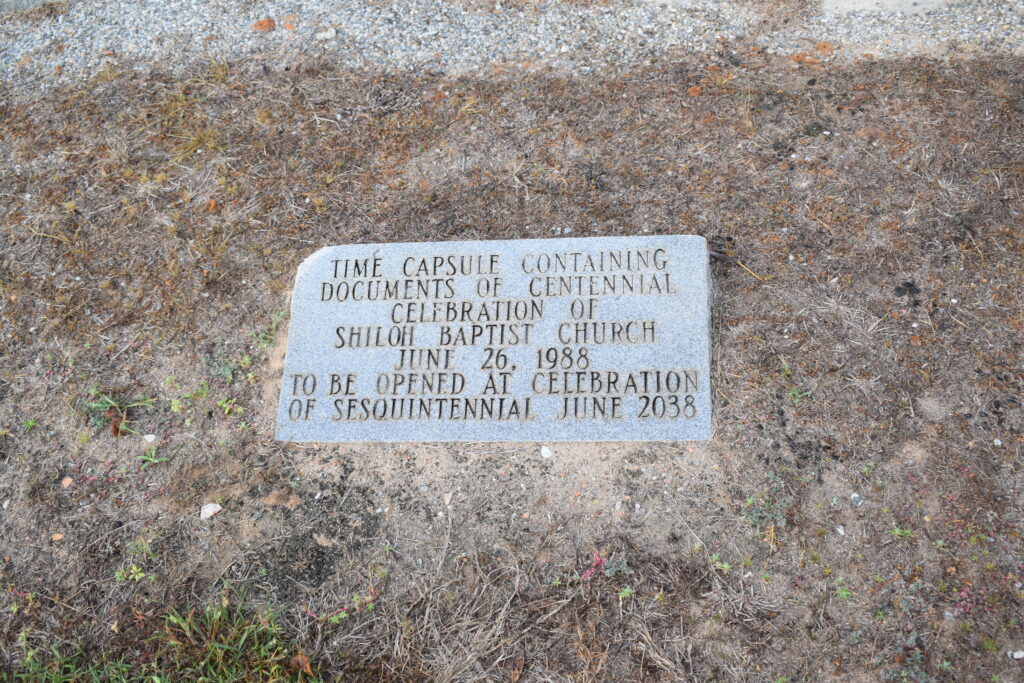 Simple ground-level stone marking a time capsule at Shiloh Baptist Church in Hartford, Alabama, sealed in 1988 and waiting to be opened in 2038.