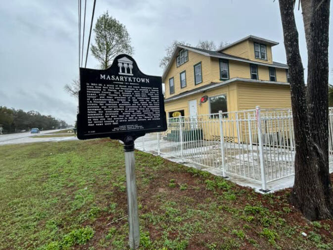 Historic Masaryktown marker standing beside the former Masaryk Hotel, now a café, along U.S. 41 in Hernando County, Florida