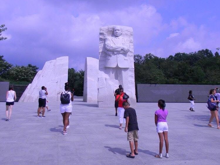 Visitors gather at the Martin Luther King Jr. Memorial in Washington, D.C., beneath the towering statue of Dr. King.
