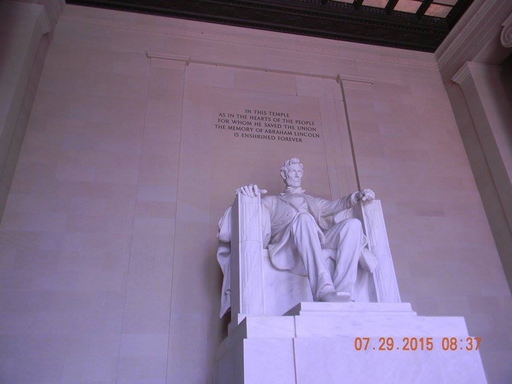 Interior view of the Lincoln Memorial featuring the large seated marble statue of Abraham Lincoln beneath the memorial inscription in Washington, D.C.