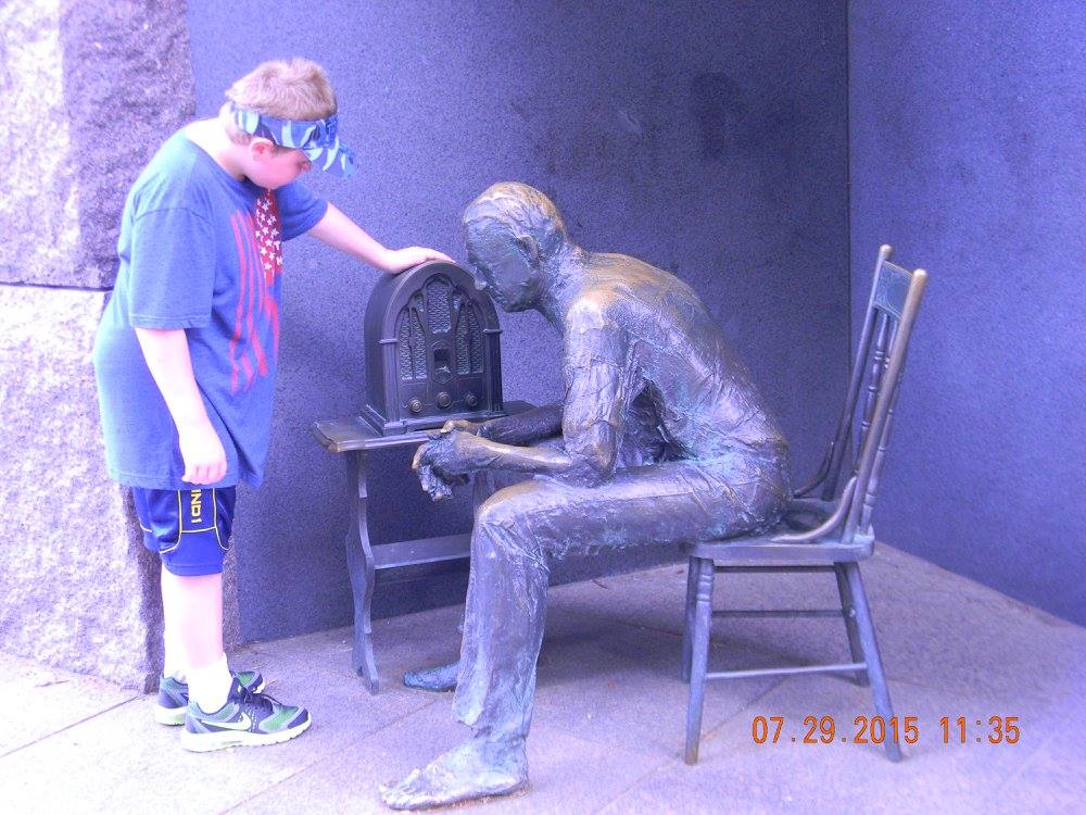 A young visitor examines the radio sculpture at the Franklin Delano Roosevelt Memorial in Washington, D.C.