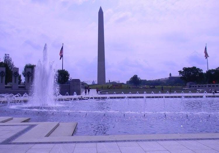 View of the Washington Monument rising beyond the fountains of the World War II Memorial on the National Mall in Washington, D.C.