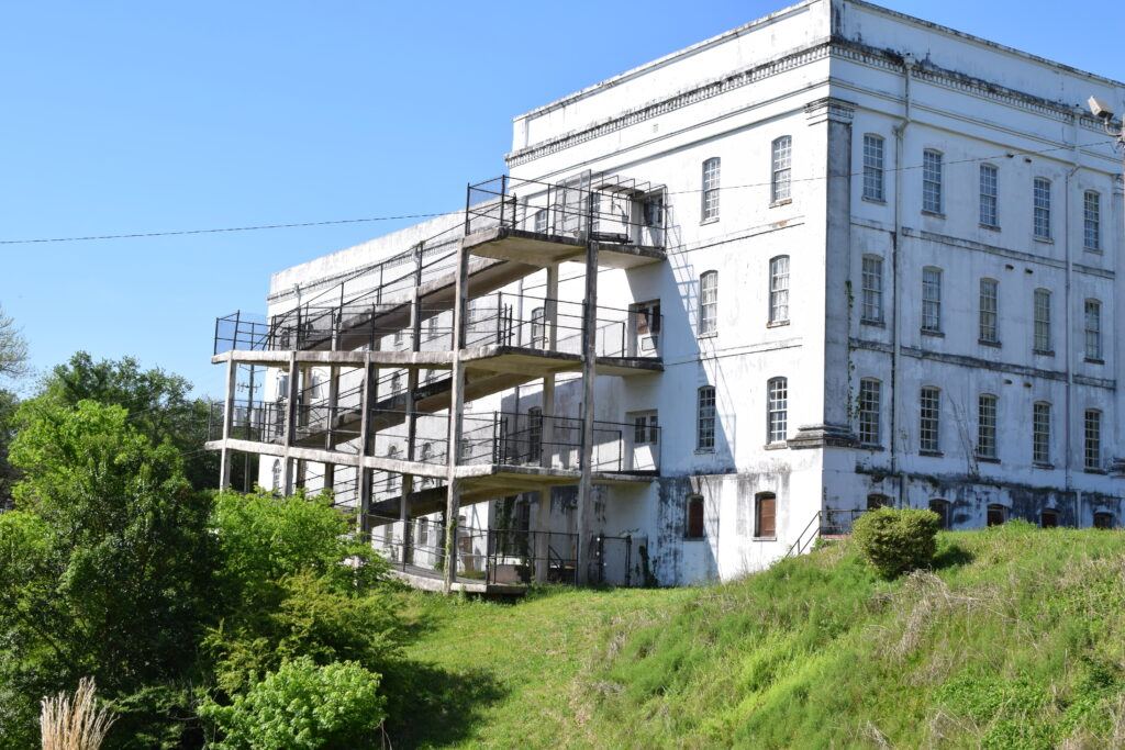 A historic multi-story hospital building with exterior stairways at Central State Hospital in Milledgeville, Georgia.
