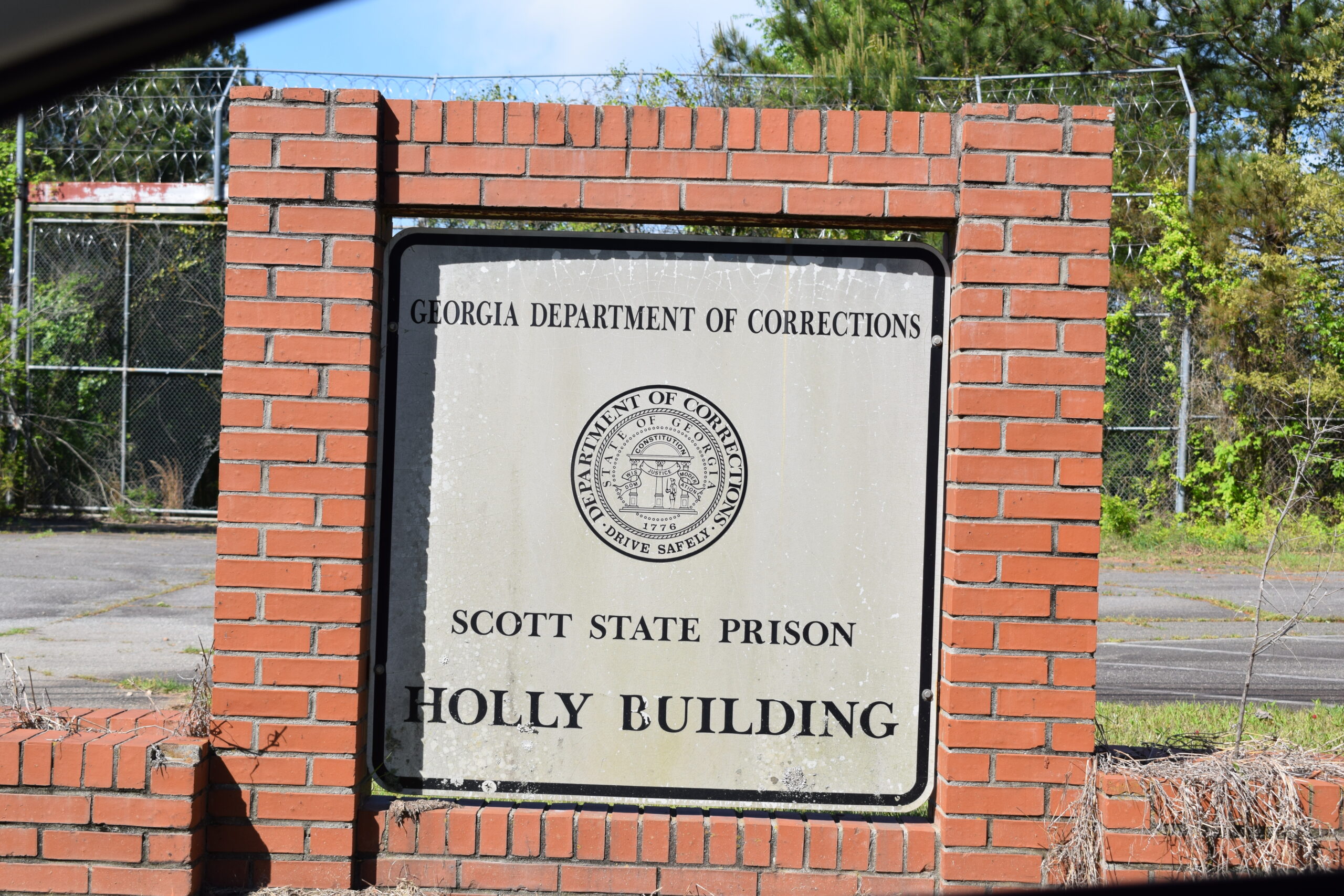 Weathered Scott State Prison entrance sign for the Holly Building at the abandoned Georgia Department of Corrections facility in Milledgeville, Georgia.