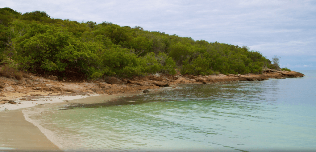 Calm turquoise water along the sandy and rocky shoreline of Playa Sucia in Cabo Rojo, Puerto Rico.