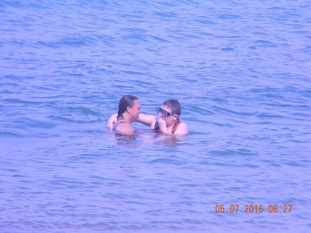 Mother and son enjoying the calm Caribbean water together at Combate Beach in Cabo Rojo, Puerto Rico.