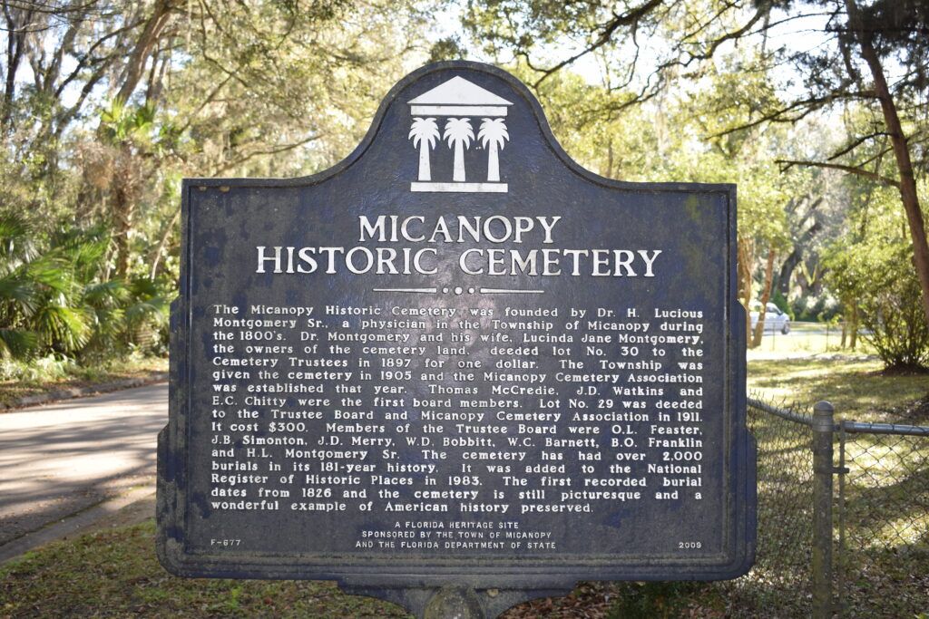 Micanopy Historic Cemetery historical marker beneath oak trees in Micanopy, Florida