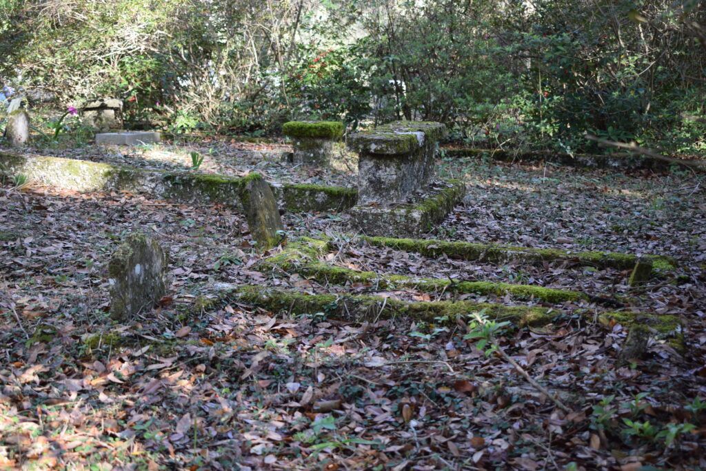 Moss-covered historic graves and weathered markers at Micanopy Historic Cemetery in Florida