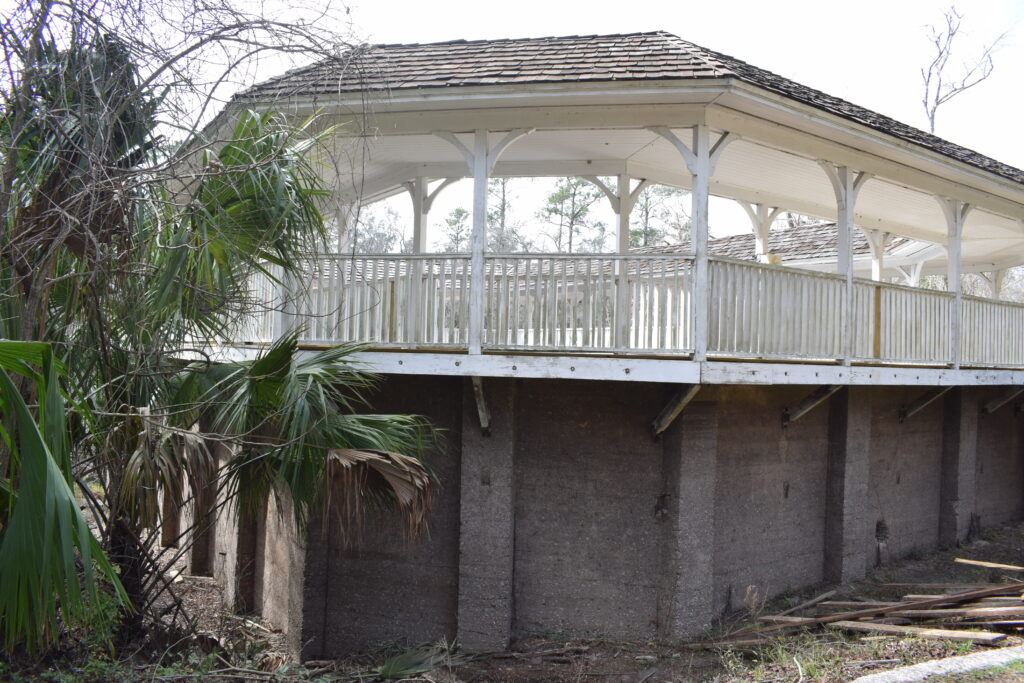 Historic White Springs Sulfur Bathhouse with its white wooden gallery above the concrete spring enclosure in White Springs, Florida.