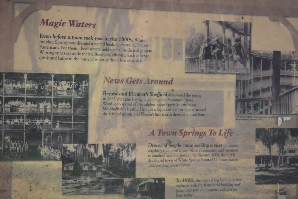 Historic interpretive display showing early visitors, bathhouses, and hotels at White Sulphur Springs, Florida.