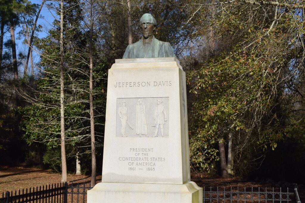 Bronze bust of Jefferson Davis atop the memorial monument at the Jefferson Davis Memorial Historic Site near Irwinville, Georgia, with a relief depicting his capture by Union soldiers.
