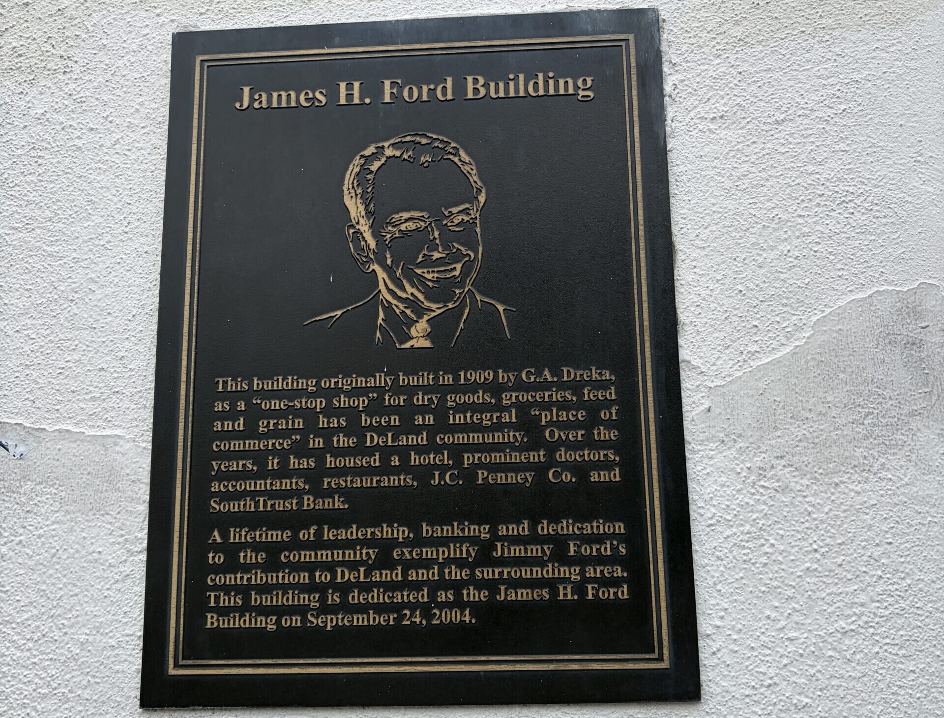 Bronze James H. Ford Building dedication plaque on the historic Dreka Building in downtown DeLand, Florida.