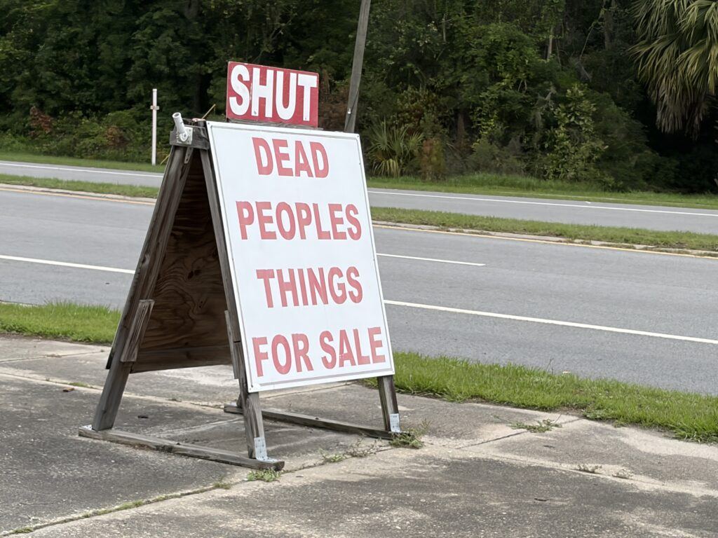 Dead People’s Things for Sale roadside sign with a SHUT sign above it in Woodbine, Georgia