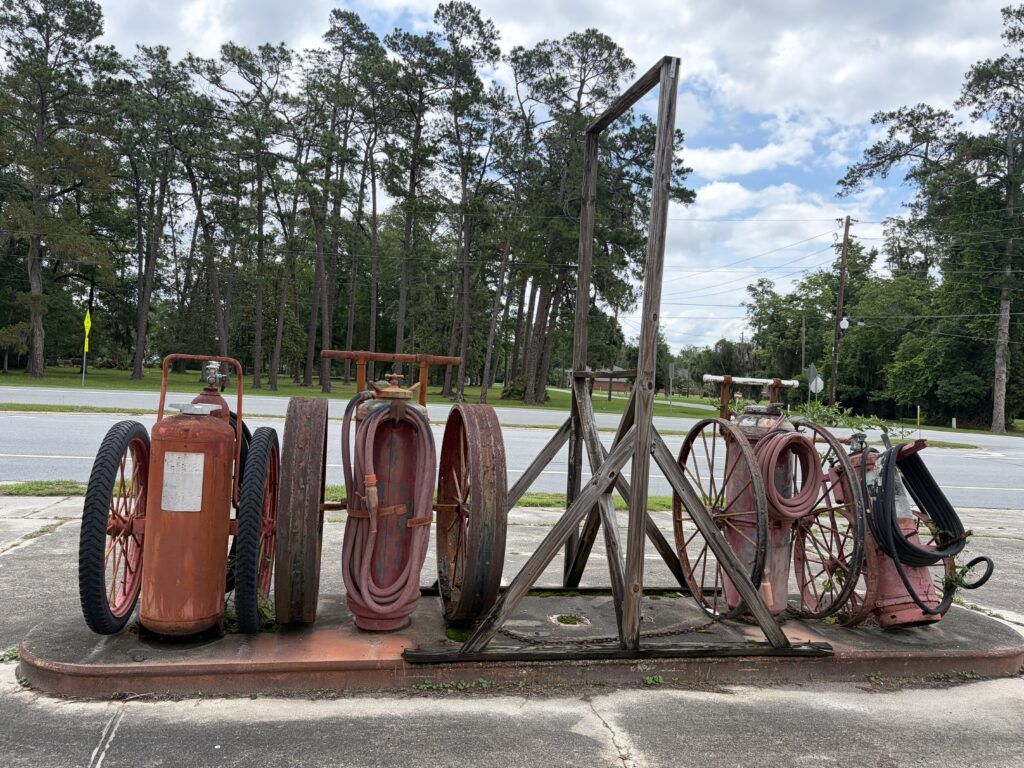 Vintage wheeled fire extinguishers and firefighting equipment outside the former Me and My Partner antique shop in Woodbine, Georgia