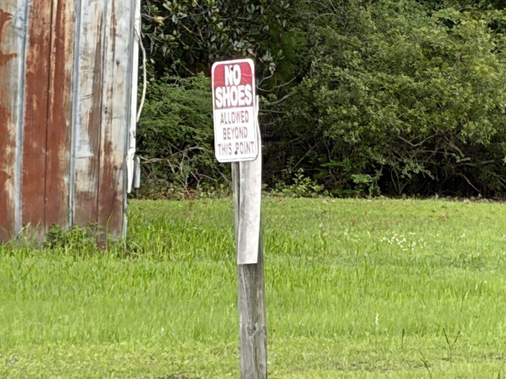 No Shoes Allowed Beyond This Point sign behind the Dead People’s Things for Sale antique shop in Woodbine, Georgia