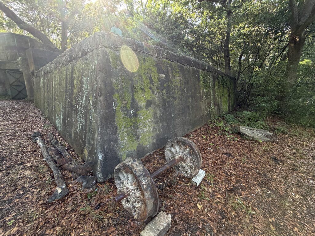 Weathered concrete and rusted structural remains beside a battery at Fort Fremont on St. Helena Island, South Carolina.