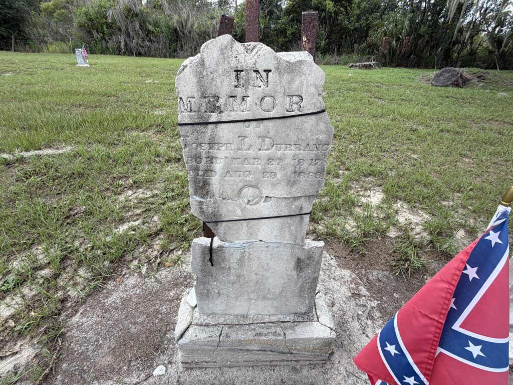 Broken and repaired headstone of Joseph L. Durrance at Crum-Durrance Cemetery near Homeland, Florida.