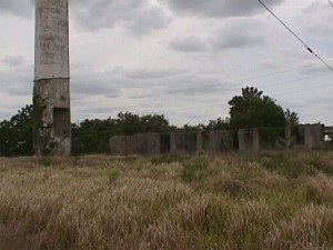 Historic photograph of Brewster’s smokestack and remaining industrial structures after the residential company town closed.