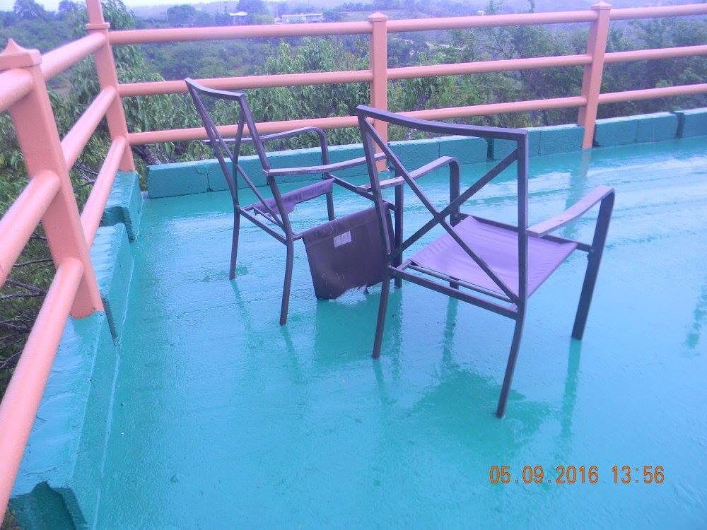 Overturned patio chair on the miradora at my parents' home in Puerto Rico after Paco jumped on my son and broke the chair.