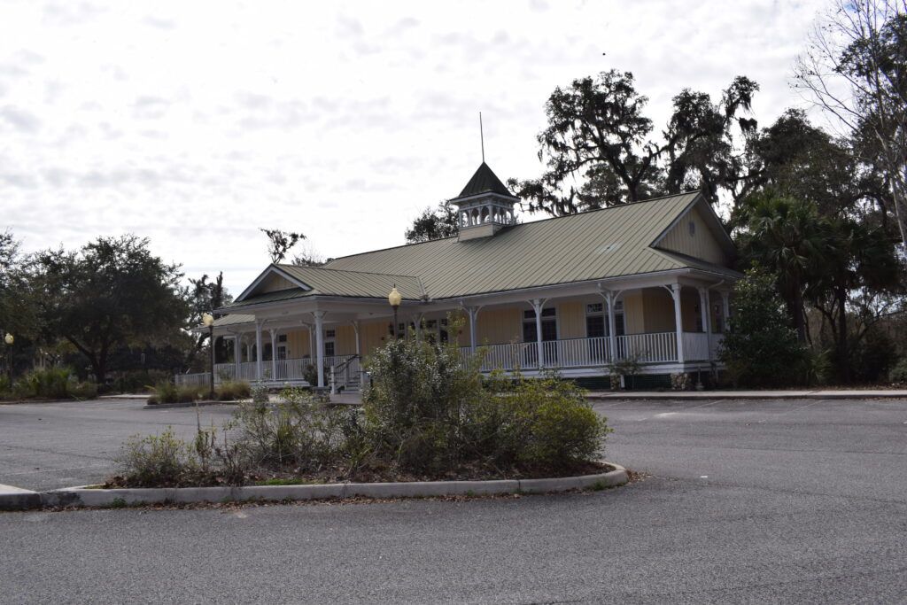 Historic building with a wraparound porch and cupola in White Springs, Florida.