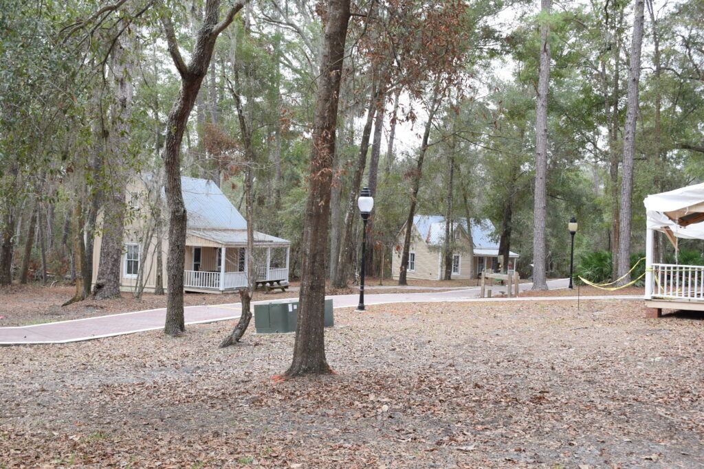 Historic-style craft buildings surrounded by trees at Craft Square in Stephen Foster Folk Culture Center State Park in White Springs, Florida.