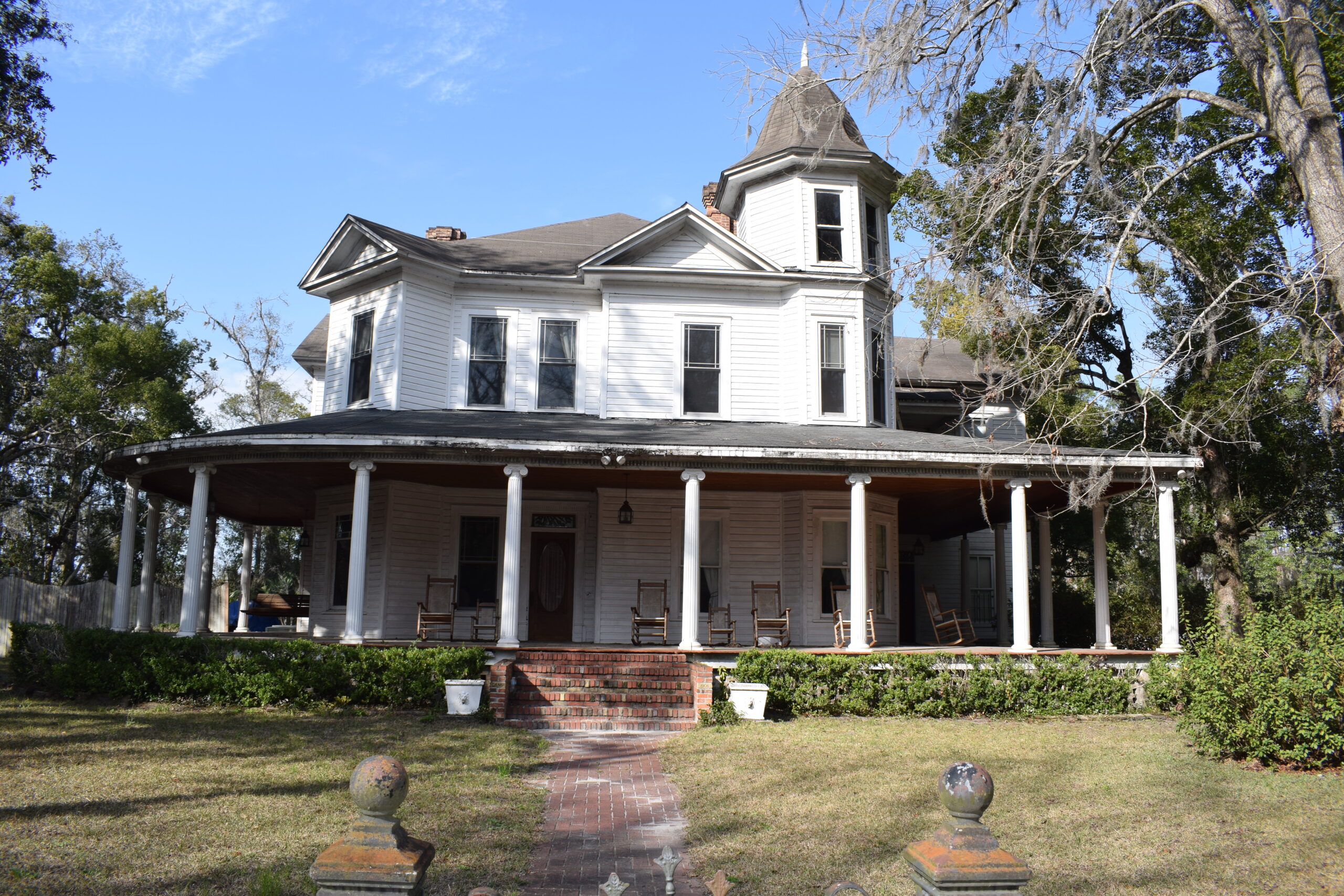 Historic white home with a wraparound porch in the White Springs Historic District in White Springs, Florida.