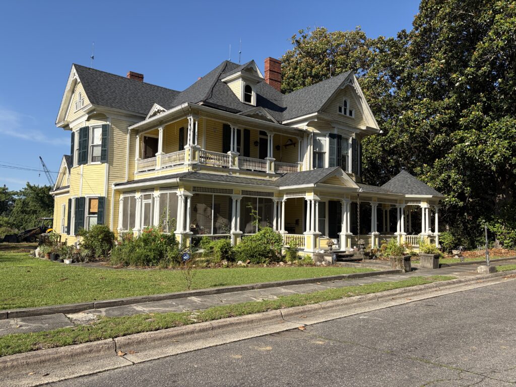 Luther Henry Caldwell House in Lumberton, North Carolina, showing its double-tier porch, multiple gables, decorative woodwork, and Queen Anne design.