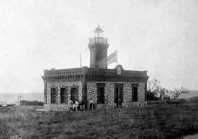 Historic black-and-white photograph of the original Punta Higüero Lighthouse and keeper’s residence in Rincón, Puerto Rico.