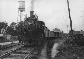 Historic steam locomotive and freight train on railroad tracks in Enfield, North Carolina.