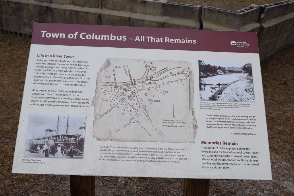 Interpretive sign titled "Town of Columbus โ All That Remains" at Suwannee River State Park, featuring a historic town map, steamboat photographs, and the history of the vanished Florida river community.