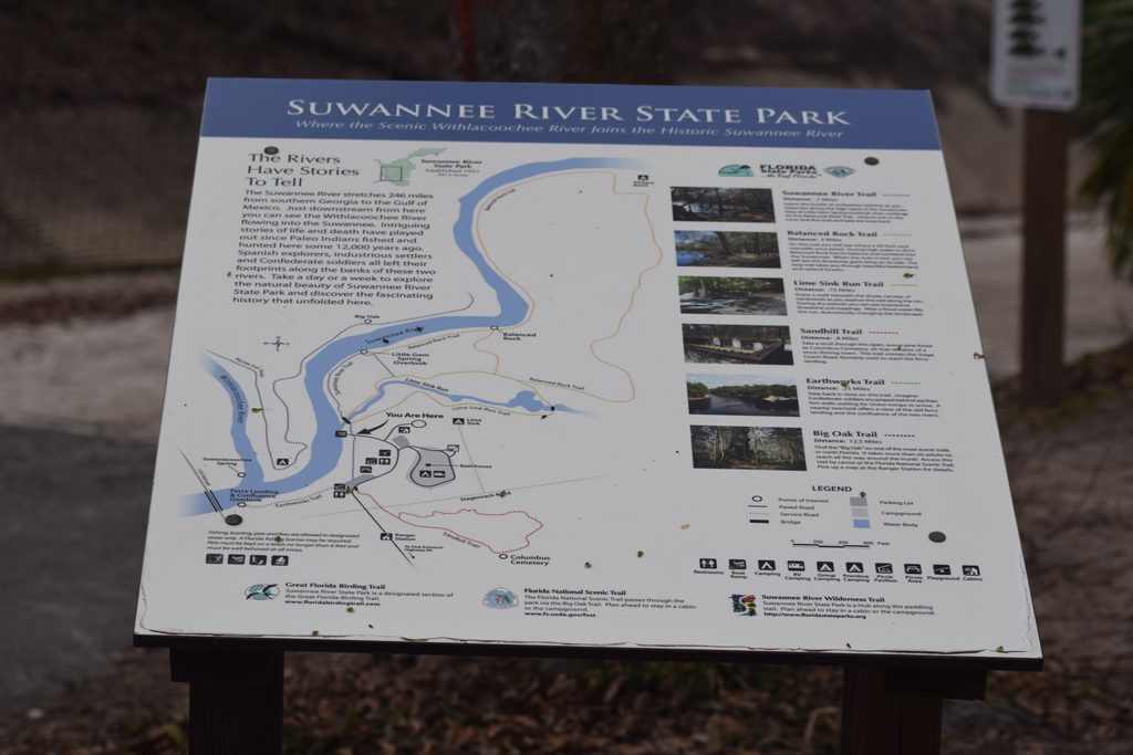 Visitor trail map at Suwannee River State Park showing the Suwannee and Withlacoochee Rivers, Columbus Cemetery, Earthworks Trail, and surrounding hiking routes.